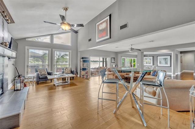 7801 Georgeann St, Winter Park, FL 32792 - dining area featuring ceiling fan, light wood-style floors, and high vaulted ceiling