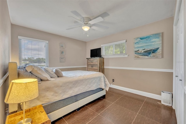 7801 Georgeann St, Winter Park, FL 32792 - bedroom featuring dark tile patterned flooring and a ceiling fan