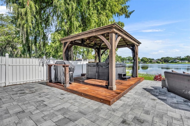 7801 Georgeann St, Winter Park, FL 32792 - view of patio / terrace with a gazebo, a hot tub, a deck with water view, and a grill