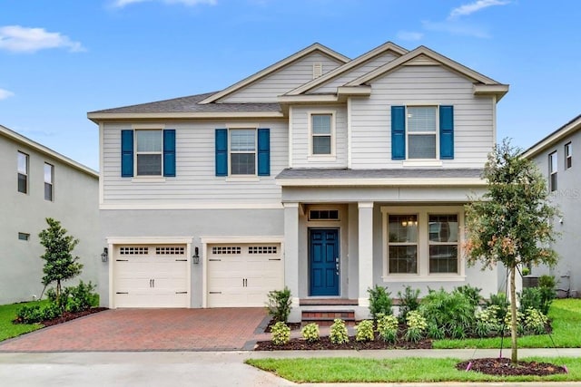 16146 Point Rock Dr, Winter Garden, FL 34787 - view of front of property featuring decorative driveway, an attached garage, and a shingled roof