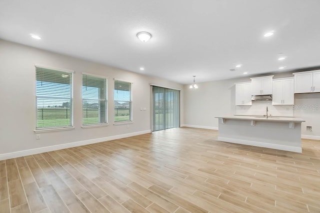 16146 Point Rock Dr, Winter Garden, FL 34787 - unfurnished living room with light wood finished floors and recessed lighting