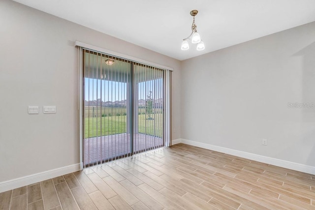 16146 Point Rock Dr, Winter Garden, FL 34787 - spare room featuring light wood-style flooring and a chandelier