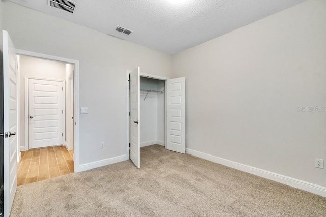 16146 Point Rock Dr, Winter Garden, FL 34787 - unfurnished bedroom featuring carpet flooring, a textured ceiling, and a closet