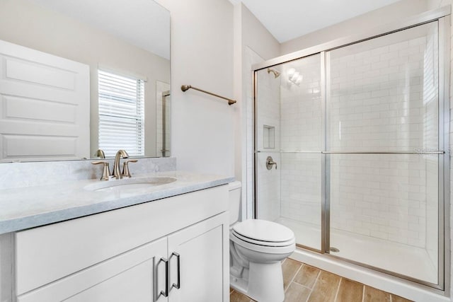 16146 Point Rock Dr, Winter Garden, FL 34787 - full bathroom with vanity, a stall shower, and wood finished floors