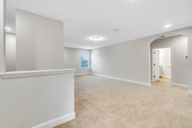 16146 Point Rock Dr, Winter Garden, FL 34787 - spare room with arched walkways, light colored carpet, and recessed lighting