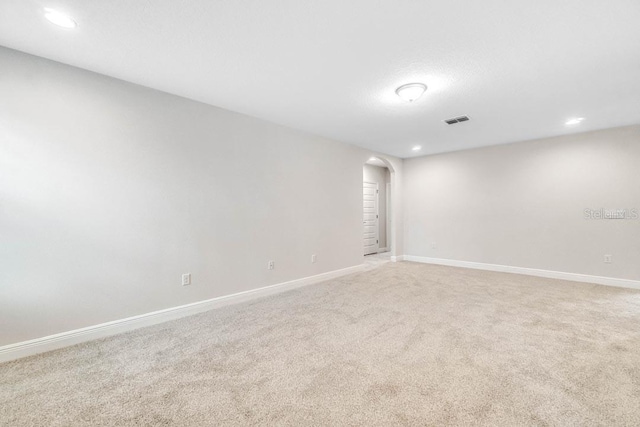 16146 Point Rock Dr, Winter Garden, FL 34787 - spare room featuring arched walkways, recessed lighting, and light colored carpet