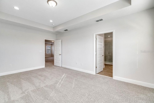 16146 Point Rock Dr, Winter Garden, FL 34787 - unfurnished bedroom with carpet, recessed lighting, connected bathroom, and a tray ceiling
