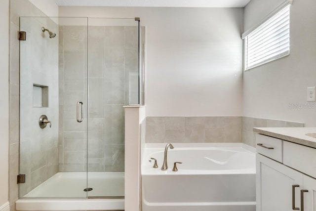 16146 Point Rock Dr, Winter Garden, FL 34787 - bathroom with a shower stall, a garden tub, and vanity