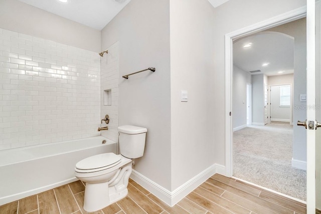 16146 Point Rock Dr, Winter Garden, FL 34787 - bathroom with wood tiled floors, bathing tub / shower combination, and recessed lighting