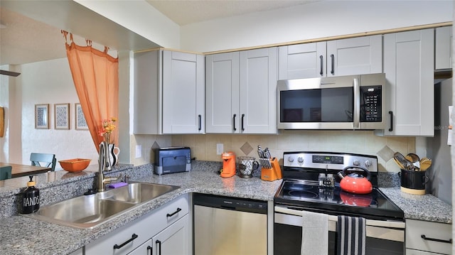 145 N Halifax Ave Unit 705, Daytona Beach, FL 32118 - kitchen with appliances with stainless steel finishes and backsplash