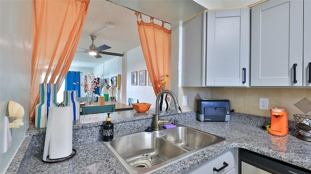 145 N Halifax Ave Unit 705, Daytona Beach, FL 32118 - kitchen featuring a ceiling fan, decorative backsplash, stainless steel dishwasher, light stone counters, and white cabinetry