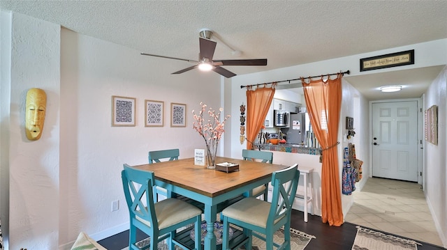 145 N Halifax Ave Unit 705, Daytona Beach, FL 32118 - dining room featuring a textured ceiling, ceiling fan, and dark tile patterned floors