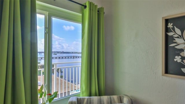 145 N Halifax Ave Unit 705, Daytona Beach, FL 32118 - bedroom with a water view and a textured wall