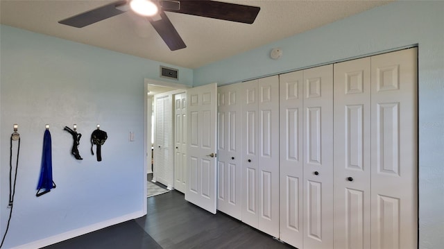 145 N Halifax Ave Unit 705, Daytona Beach, FL 32118 - unfurnished bedroom with dark wood finished floors, a ceiling fan, and a closet