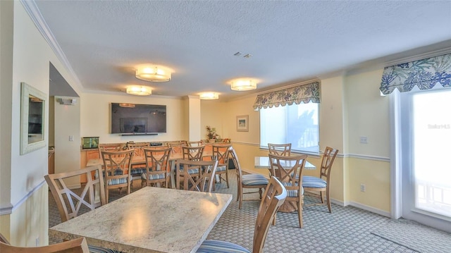 145 N Halifax Ave Unit 705, Daytona Beach, FL 32118 - dining area with healthy amount of natural light, ornamental molding, a textured ceiling, and light colored carpet