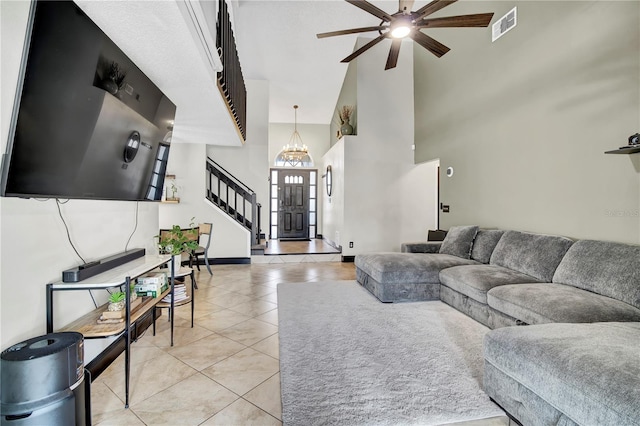 2235 Meadowmouse St, Orlando, FL 32837 - living room with ceiling fan, light tile patterned flooring, a towering ceiling, and stairway