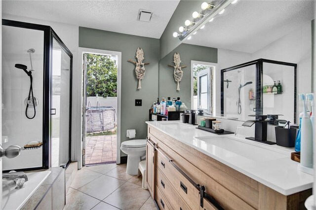 2235 Meadowmouse St, Orlando, FL 32837 - bathroom with a shower stall, vanity, a textured ceiling, and tile patterned flooring