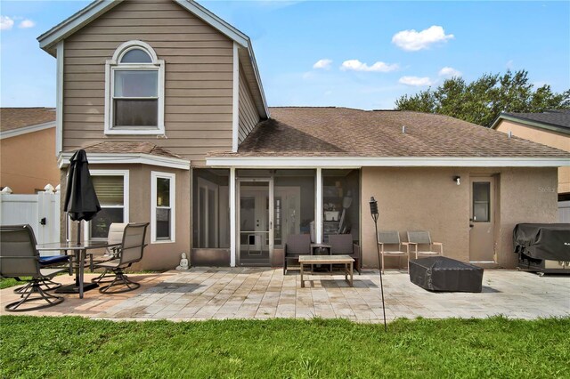 2235 Meadowmouse St, Orlando, FL 32837 - back of house featuring roof with shingles, a sunroom, a patio area, a fire pit, and stucco siding