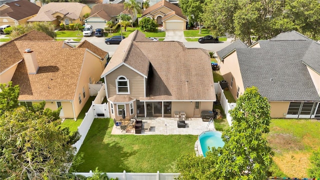 2235 Meadowmouse St, Orlando, FL 32837 - rear view of house featuring a residential view, a fenced backyard, a patio area, roof with shingles, and stucco siding