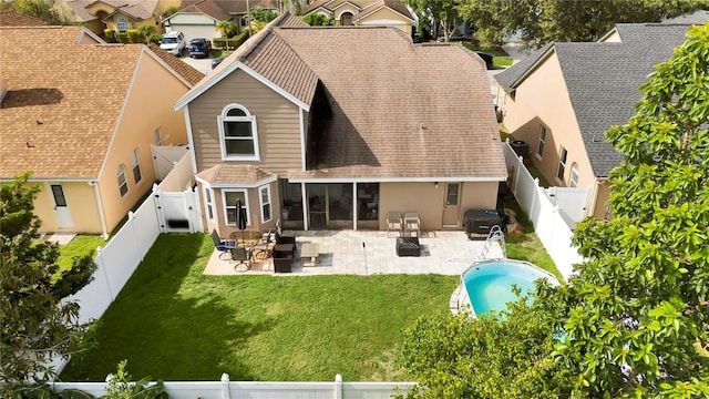 2235 Meadowmouse St, Orlando, FL 32837 - rear view of property featuring a fenced backyard, a shingled roof, a gate, and a patio area