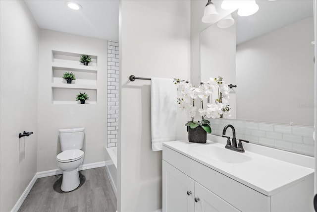 370 Hand Ave, Ormond Beach, FL 32174 - full bath featuring vanity, wood finished floors, bathing tub / shower combination, backsplash, and recessed lighting