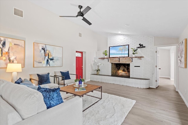 370 Hand Ave, Ormond Beach, FL 32174 - living area featuring lofted ceiling, wood finished floors, a brick fireplace, and ceiling fan