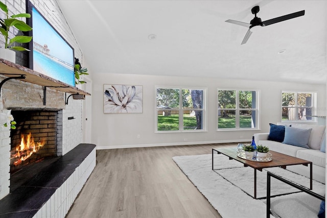 370 Hand Ave, Ormond Beach, FL 32174 - living area featuring a brick fireplace, wood finished floors, ceiling fan, and lofted ceiling
