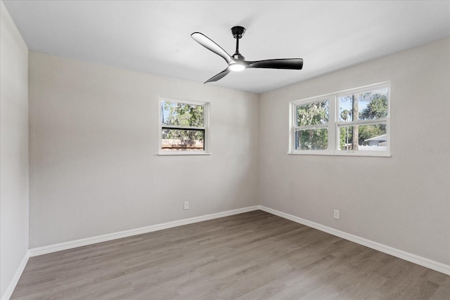 370 Hand Ave, Ormond Beach, FL 32174 - empty room featuring plenty of natural light, wood finished floors, and a ceiling fan