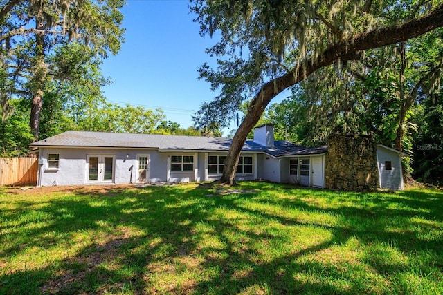 370 Hand Ave, Ormond Beach, FL 32174 - view of front facade featuring french doors, a chimney, and stucco siding