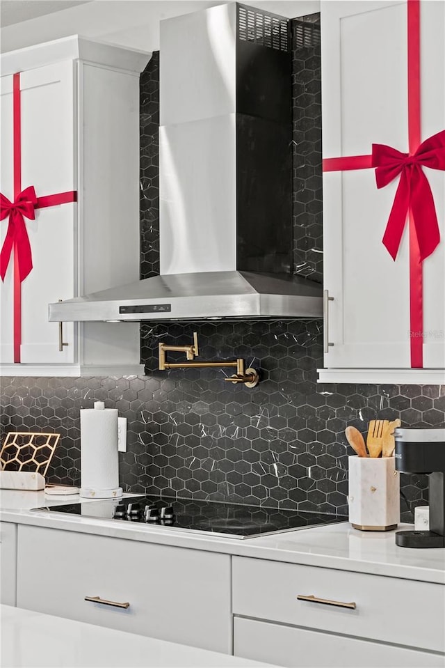 12468 Koshiba Aly, Orlando, FL 32827 - kitchen with wall chimney exhaust hood, backsplash, and white cabinets