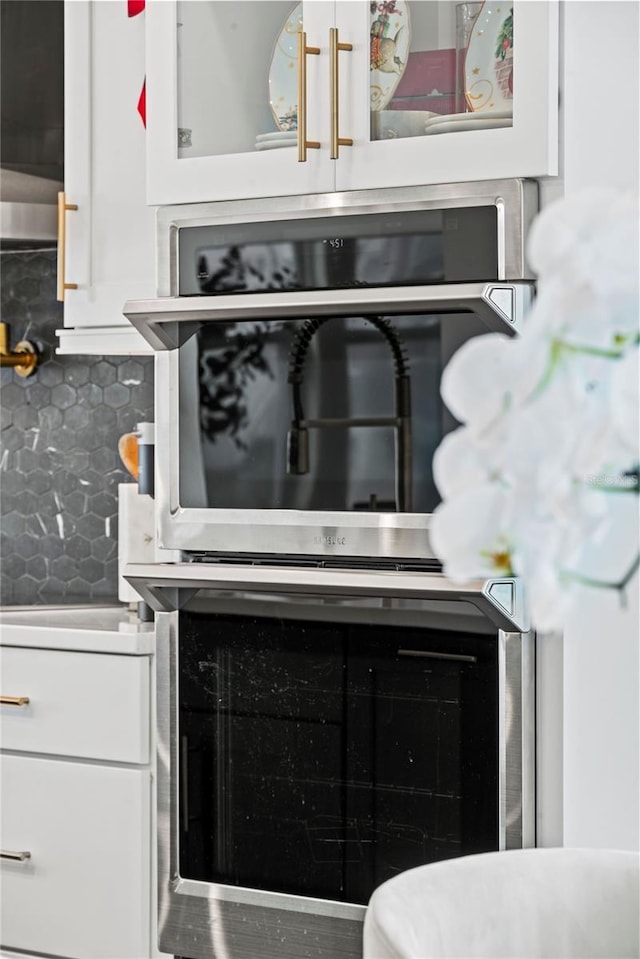 12468 Koshiba Aly, Orlando, FL 32827 - kitchen view of white cabinetry, backsplash, and pot filler