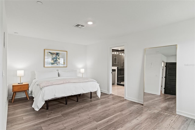 12468 Koshiba Aly, Orlando, FL 32827 - bedroom featuring wood finished floors and ensuite bathroom