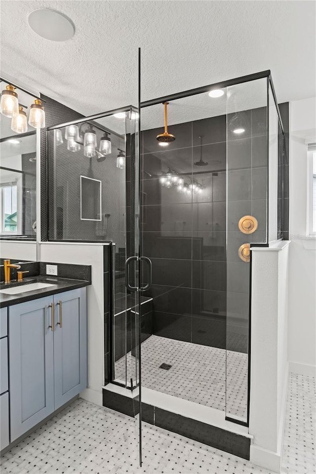 12468 Koshiba Aly, Orlando, FL 32827 - bathroom featuring a stall shower, vanity, a textured ceiling, and tile patterned floors