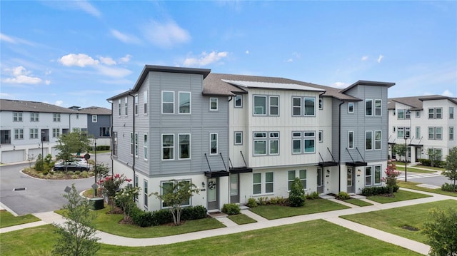 12468 Koshiba Aly, Orlando, FL 32827 - multi unit property with a residential view, a front yard, and board and batten siding