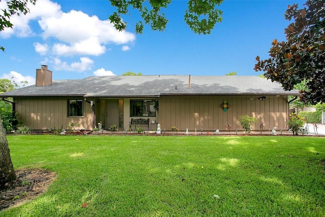 545 Mystic Wood St, Casselberry, FL 32707 - back of house featuring a chimney, a lawn, and board and batten siding