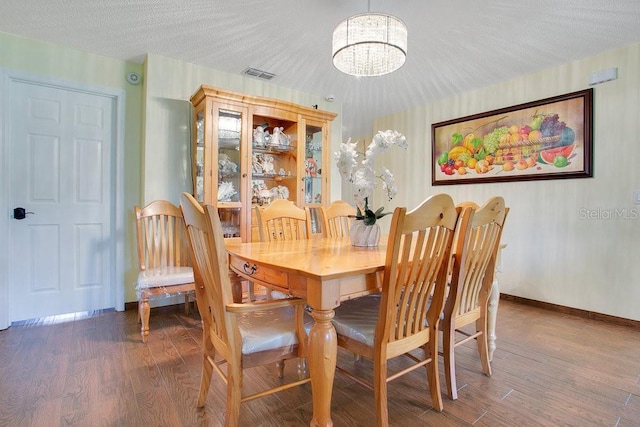 545 Mystic Wood St, Casselberry, FL 32707 - dining space featuring a chandelier, wood finished floors, and a textured ceiling