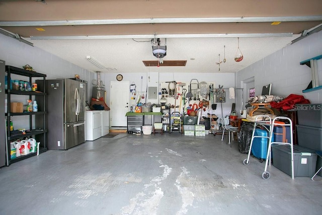 545 Mystic Wood St, Casselberry, FL 32707 - garage featuring freestanding refrigerator, concrete block wall, electric panel, a workshop area, and a garage door opener