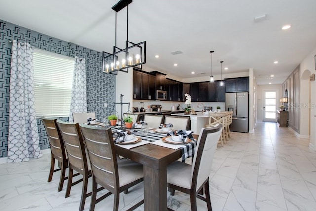 8982 Cabot Cliffs Dr, Davenport, FL 33896 - dining area featuring light marble finish floors and recessed lighting