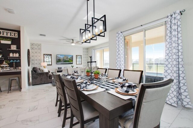 8982 Cabot Cliffs Dr, Davenport, FL 33896 - dining room featuring light marble finish flooring and ceiling fan