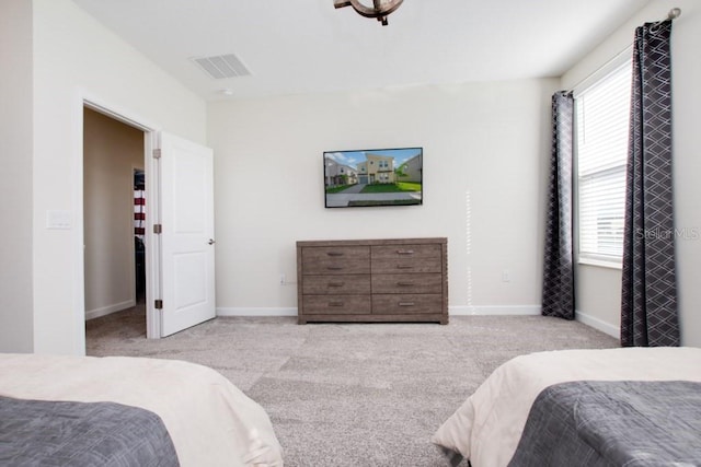8982 Cabot Cliffs Dr, Davenport, FL 33896 - bedroom featuring light colored carpet and multiple windows