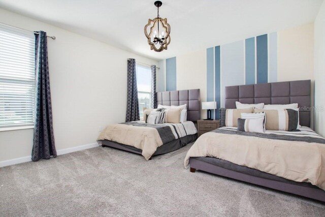 8982 Cabot Cliffs Dr, Davenport, FL 33896 - carpeted bedroom featuring a chandelier and baseboards