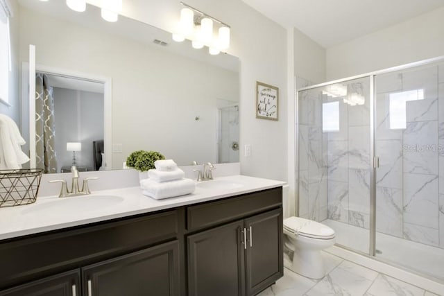 8982 Cabot Cliffs Dr, Davenport, FL 33896 - bathroom featuring double vanity, marble finish floors, and a marble finish shower