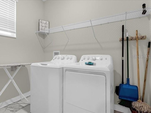 8982 Cabot Cliffs Dr, Davenport, FL 33896 - laundry room featuring separate washer and dryer and marble finish floors