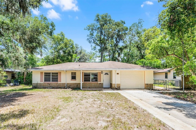 710 N Sparkman Ave, Orange City, FL 32763 - ranch-style house with stone siding, a garage, concrete driveway, and stucco siding