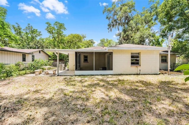 710 N Sparkman Ave, Orange City, FL 32763 - rear view of house with a sunroom and concrete block siding
