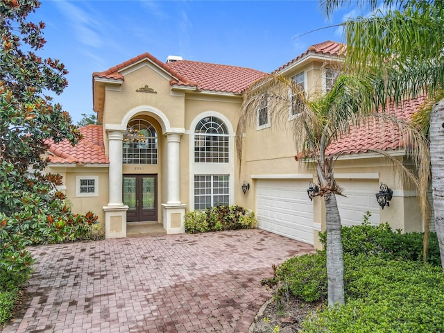 2209 Callaway Ct, Davenport, FL 33837 - mediterranean / spanish-style house with french doors, a tiled roof, and stucco siding