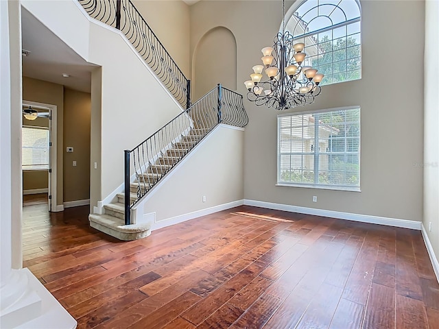 2209 Callaway Ct, Davenport, FL 33837 - entrance foyer featuring hardwood / wood-style flooring, a high ceiling, stairway, and a chandelier