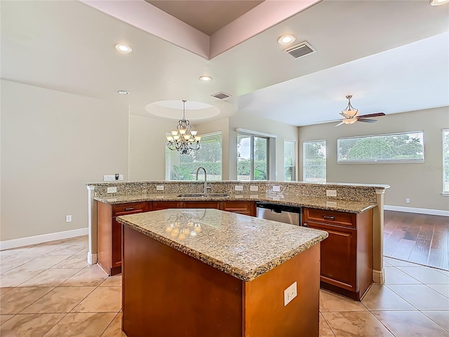 2209 Callaway Ct, Davenport, FL 33837 - kitchen featuring a center island, light tile patterned floors, dishwasher, light stone countertops, and recessed lighting