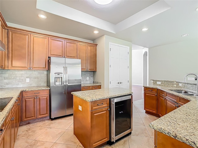 2209 Callaway Ct, Davenport, FL 33837 - kitchen with stainless steel fridge, beverage cooler, a kitchen island, light tile patterned floors, and a tray ceiling