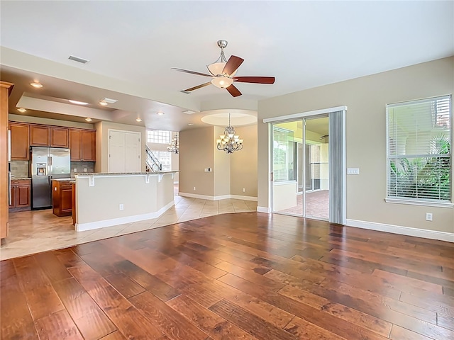2209 Callaway Ct, Davenport, FL 33837 - unfurnished living room with a chandelier, light wood finished floors, ceiling fan, and recessed lighting